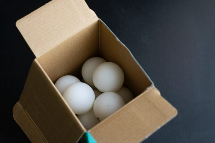 photograph of ping pong balls in a box